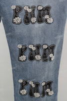 Blue embroidered damaged bell bottom jeans