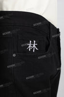 Character embroidered black stacked jeans