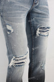 Blue damaged skinny paint splatters jeans